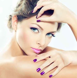 Beautiful model with lilac makeup and manicure.